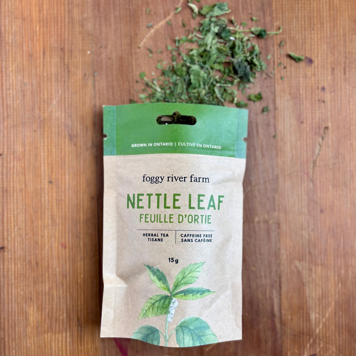 opened brown craft package of foggy river farm's nettle leaf on wooden background